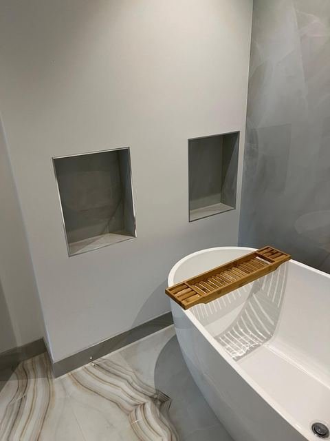 Soaking tub, recessed niches & bookmatched floors